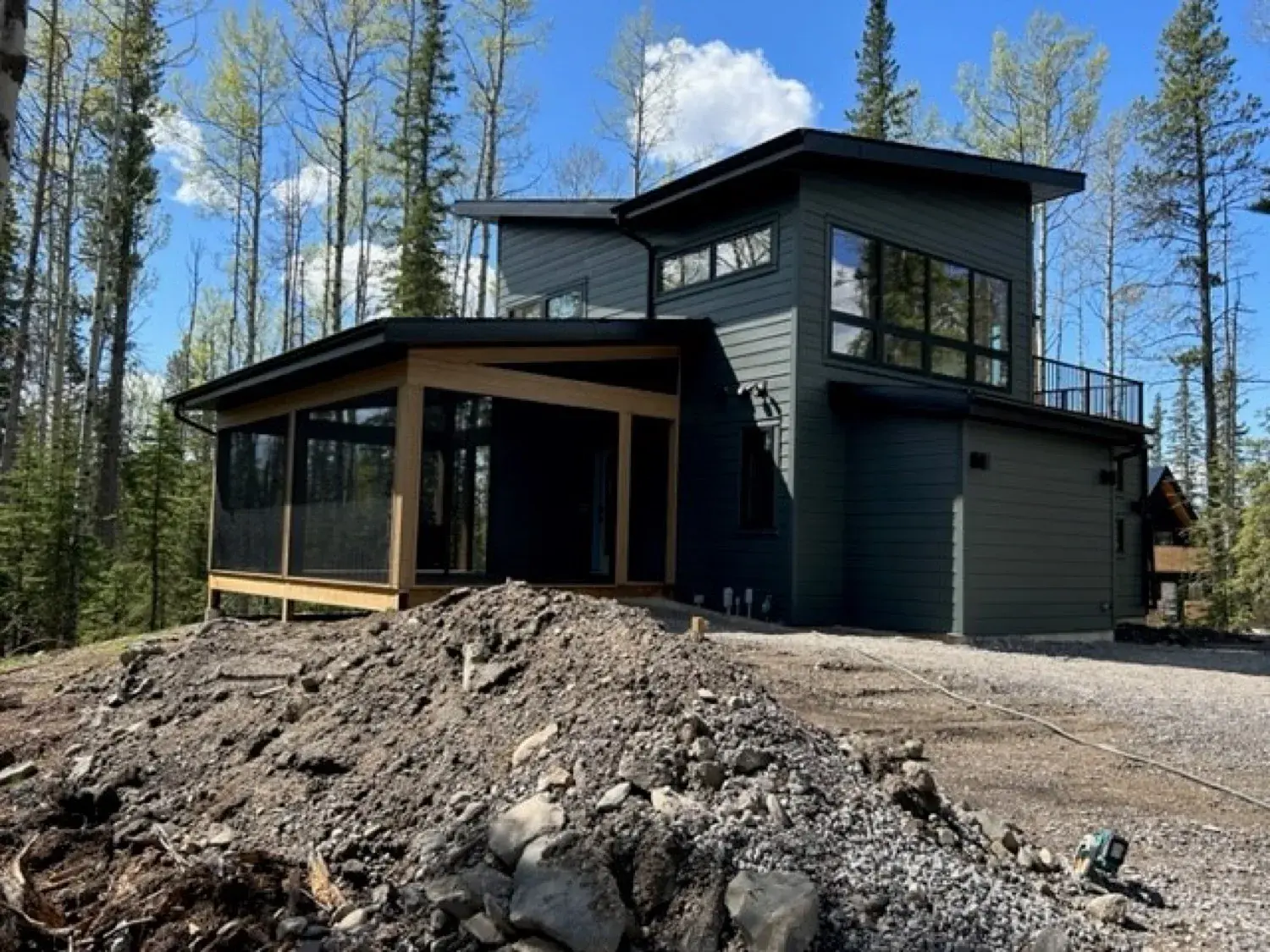 PJM screen room with a retractable screen door open on a Buffalo Lake lakefront deck, showing the full post-and-beam structure from the exterior at golden hour