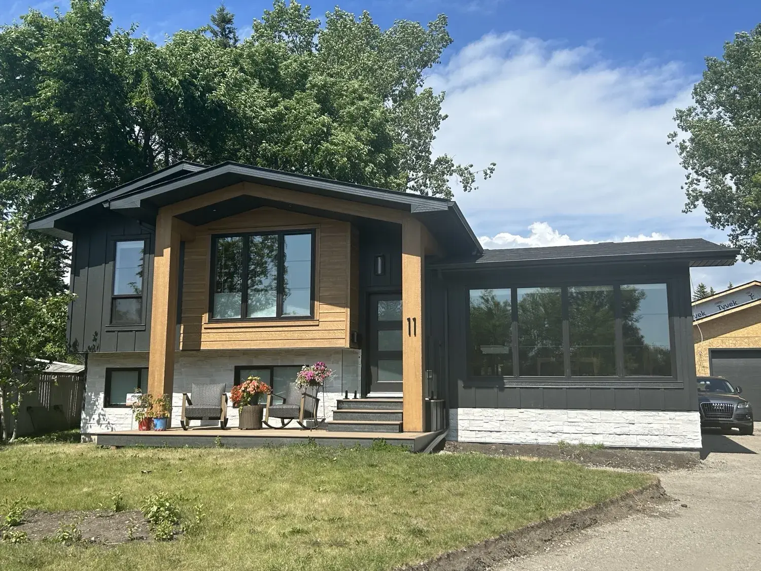 Completed exterior of a Central Alberta home by PJM Home Advantage — crisp James Hardie siding, clean soffit, fascia and seamless eavestrough lines under a clear sky
