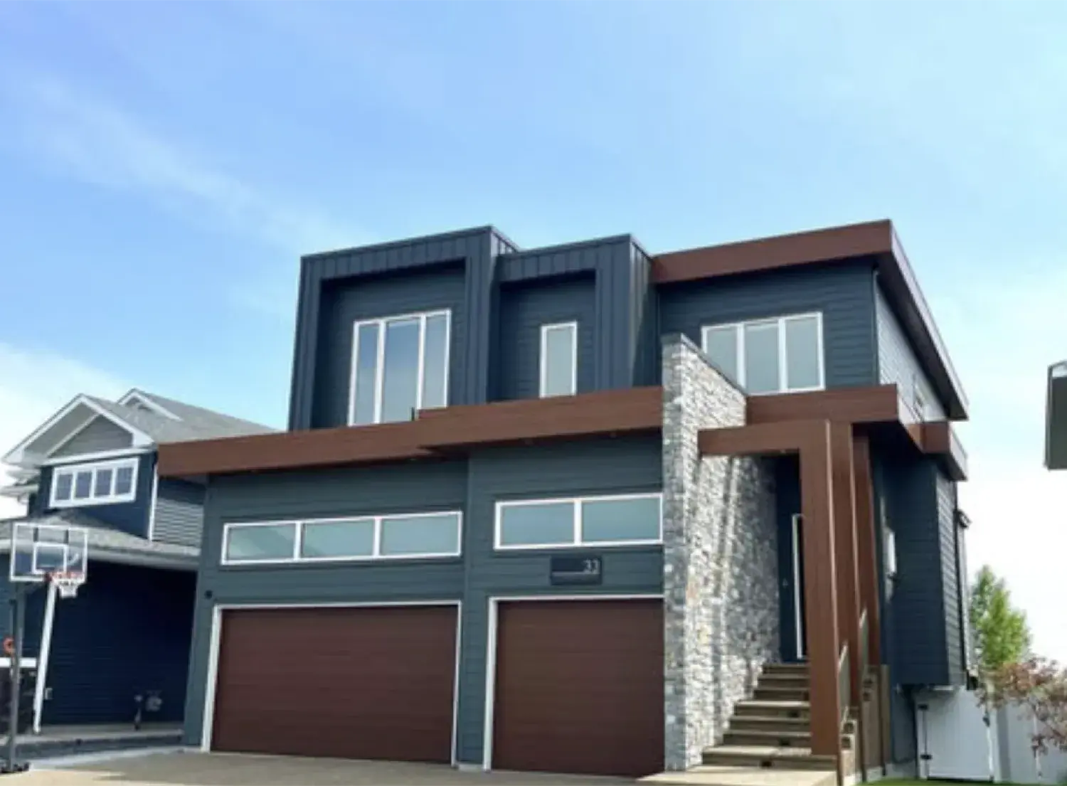 Central Alberta home with a mixed stone and wood-clad exterior finished by PJM Home Advantage